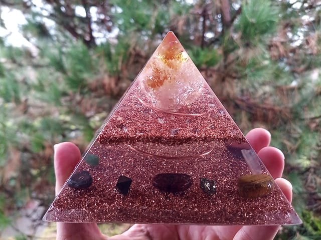 Abundance orgone pyramid with tree in the background