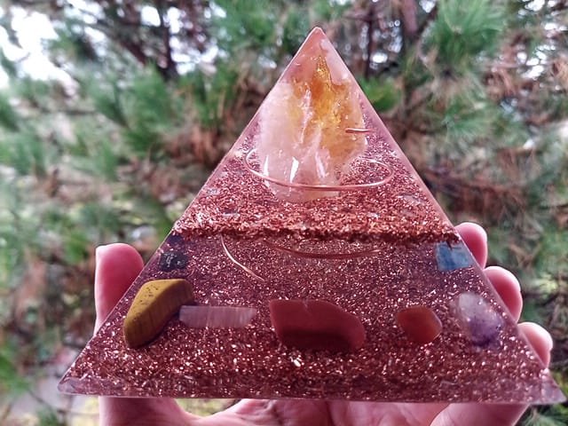 Abundance orgone pyramid with red jasper, carnelian and amethyst crystals inside.