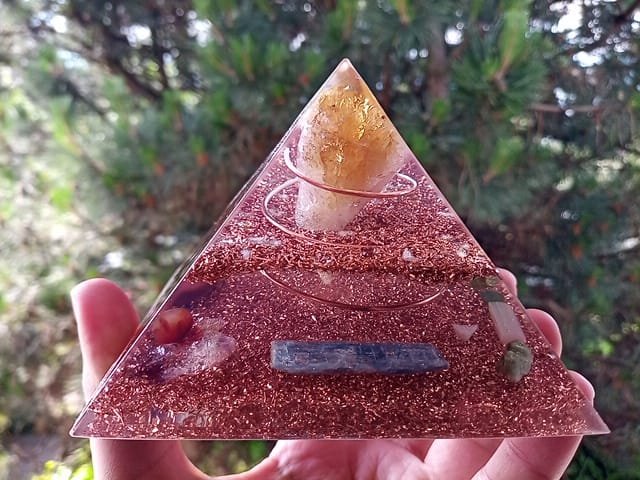 Abundance orgone pyramid with wealth crystals like citrine and emerald.