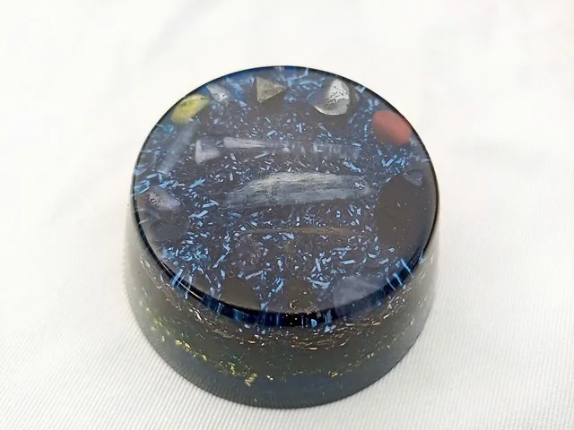 Blue Orgone puck with amethyst and rose quartz crystals.