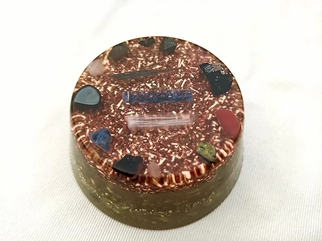 Clear Orgone Puck with blue kyanite and selenite crystals in the center.