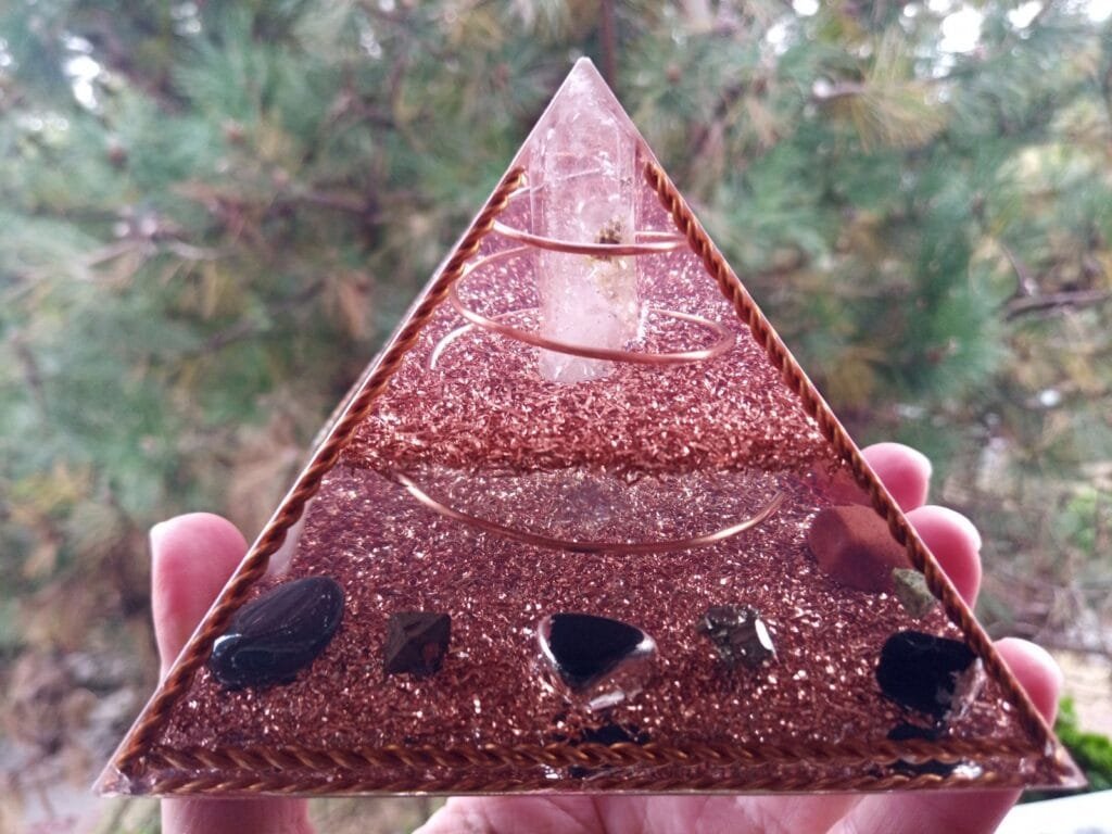 Copper Frame orgone pyramid with a braided copper wire on the sides and bottom.