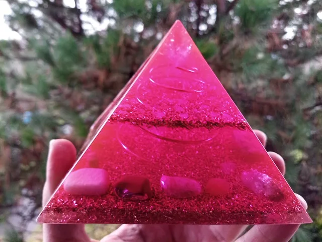 Divine love orgone pyramid with amethyst, sunstone and amazonite crystals inside.