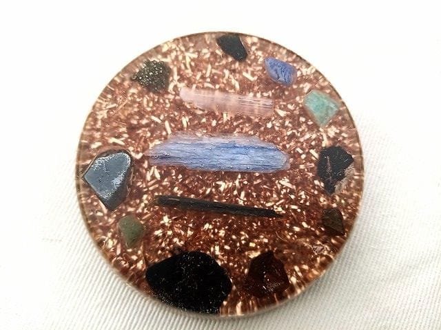 EMF orgone disc with black tourmaline, shungite and hematite grounding crystals.