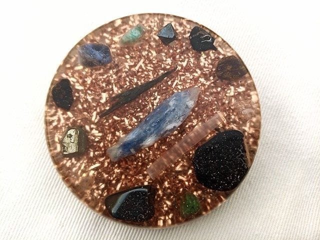 EMF orgone disc on a white cloth.