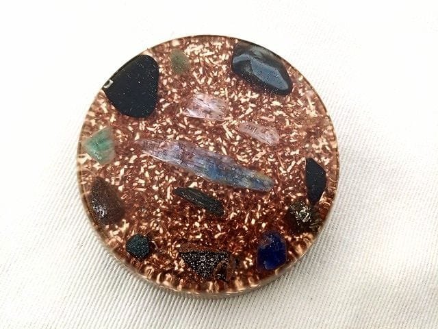 Round EMF orgone disc with crystals and copper.