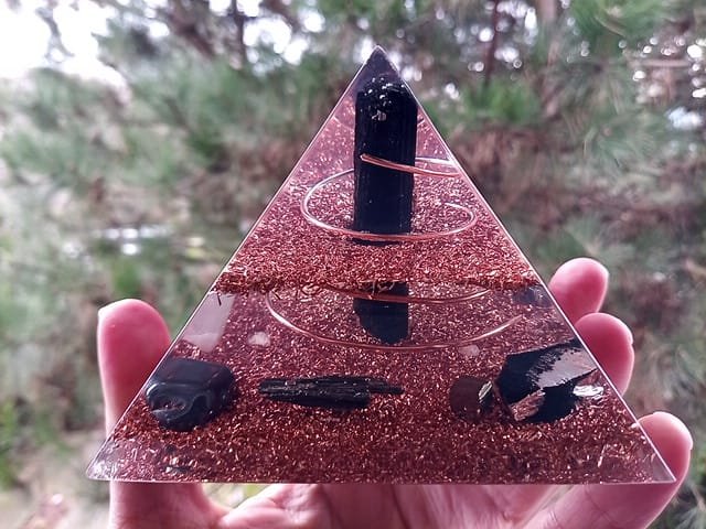 EMF orgone energy pyramid generator in front of a pine tree