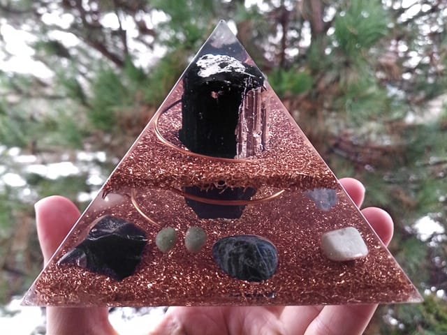 EMF orgone pyramid energy generator with a large black tourmaline in the center.