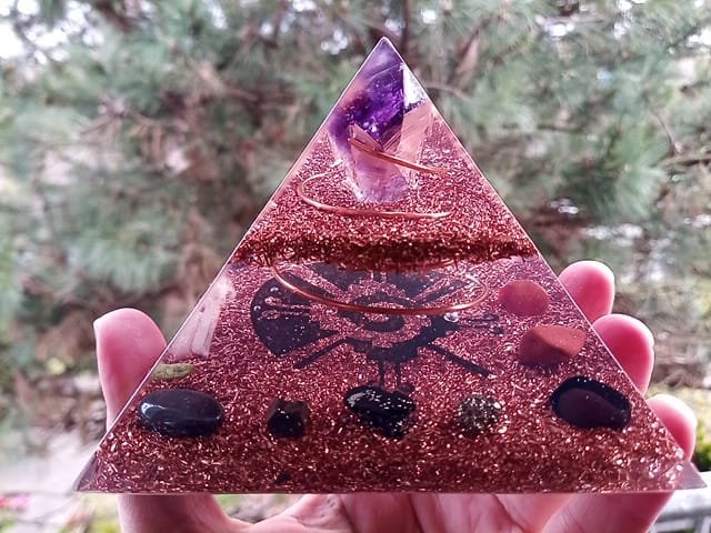 Galactic Butterfly orgone pyramid with clear resin and copper and grounding stones.