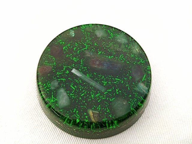 Green Heart Chakra orgone disc with blue kyanite and selenite in the center.