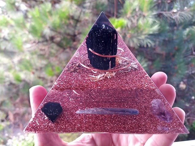 Immunity orgone pyramid with blue kyanite and amethyst crystals.