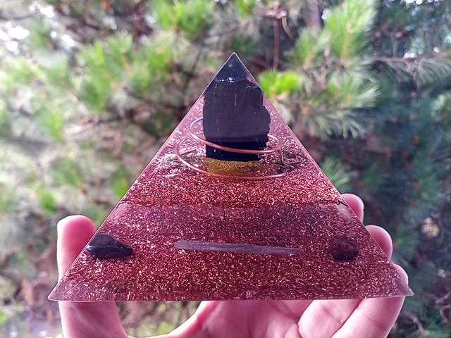 Immunity orgone pyramid with goldenseal, ginsing and holy basil in the resin.