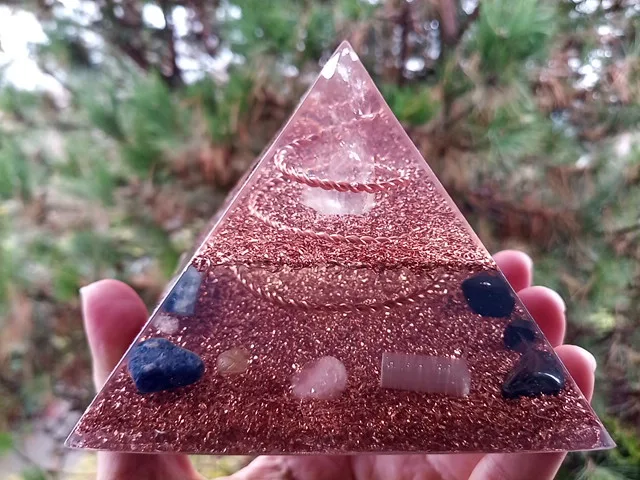 Lemurian Seed Crystal orgone energy generator with crystals in front of a tree.