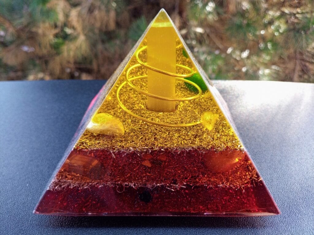 Lower Chakra orgone pyramid energy generator with selenite rod in the center.