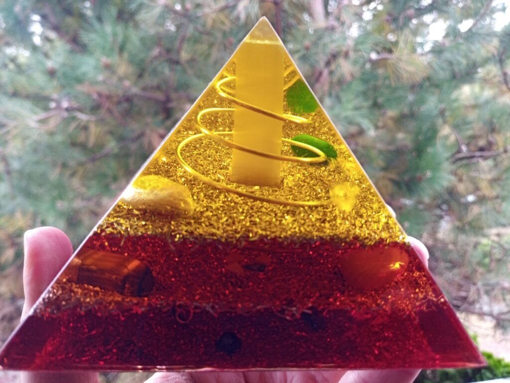 Lower Chakra orgone pyramid with selenite crystal, yellow, orange, red colors.