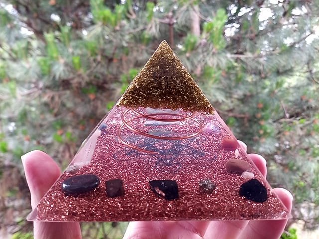 Metatron's Cube Orgone Pyramid with protection crystals in front of tree.