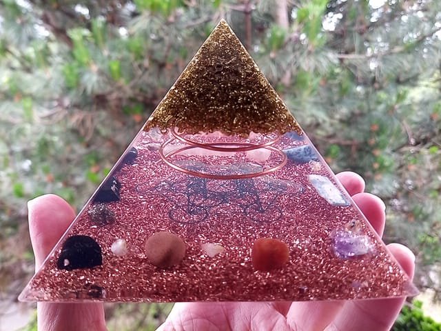 Metatron's Cube Orgone Pyramid with red jasper, carnelian and quartz crystals.