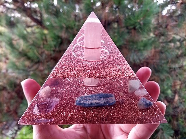 Selenite orgone pyramid with blue kyanite, amethyst and blue sodalite crystals.