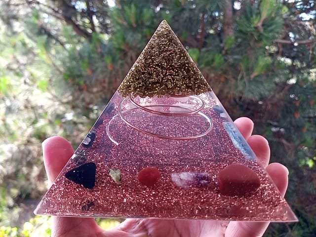 Sri Yantra orgone energy pyramid with chakra crystals red jasper and carnelian.