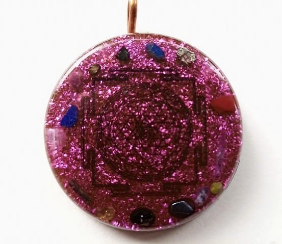 Violet Sri Yantra orgone pendant with amethyst and clear quartz crystals.