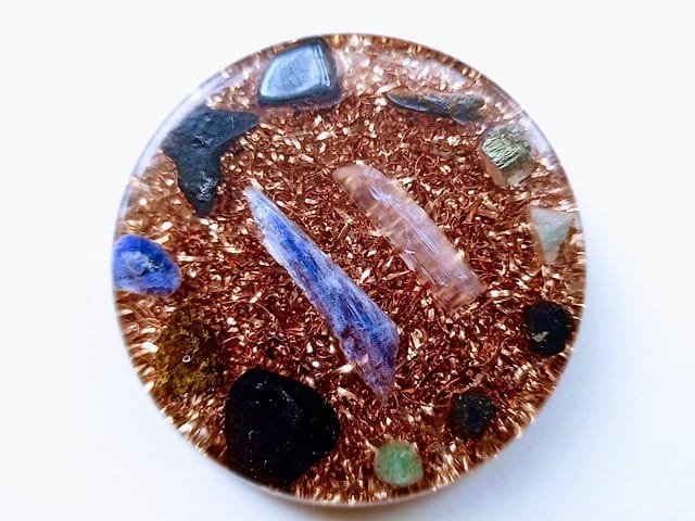 Large Orgone EMF disc with crystals and copper on a white background