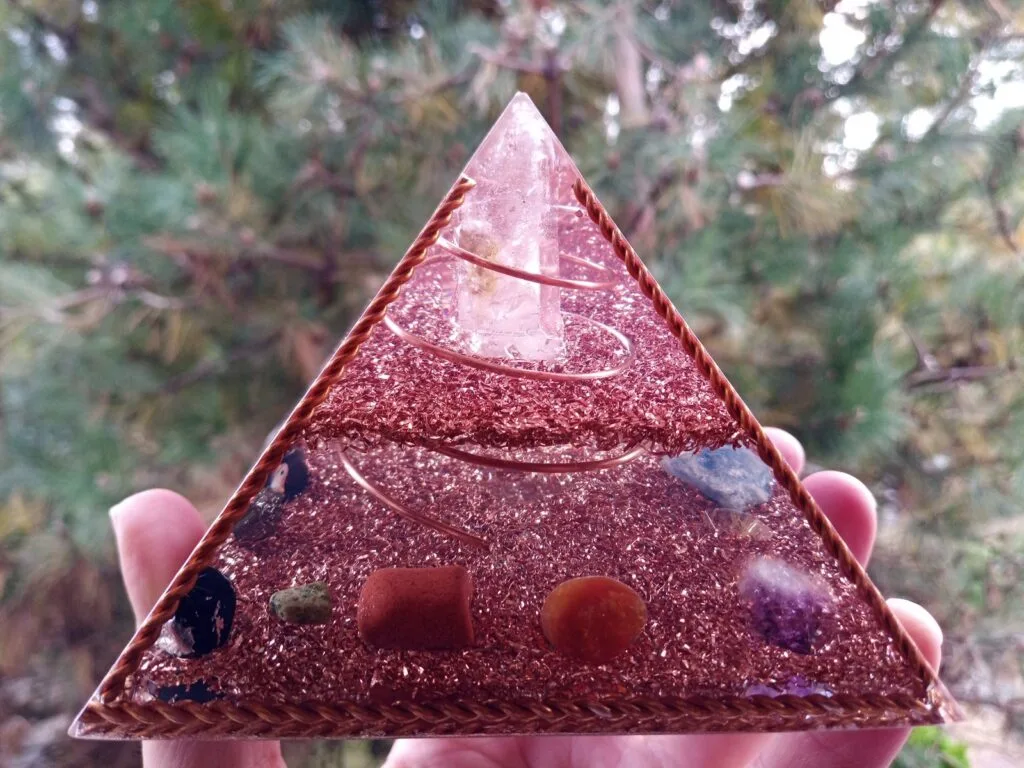 Copper Frame orgone pyramid with red jasper and carnelian crystals.