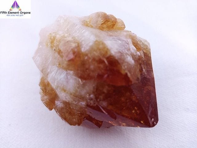 Citrine point crystal on a white background