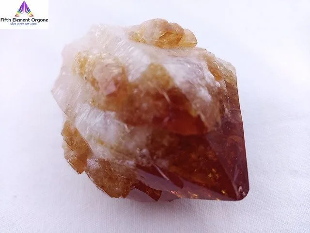 Citrine point crystal on a white background