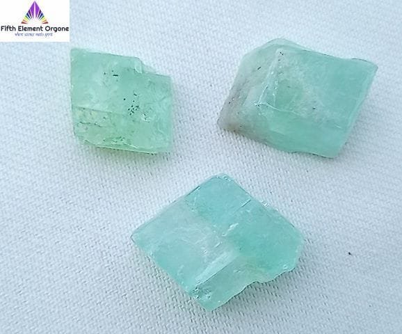 Green Calcite crystals on a white background.
