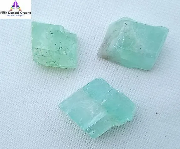 Green Calcite crystals on a white background.